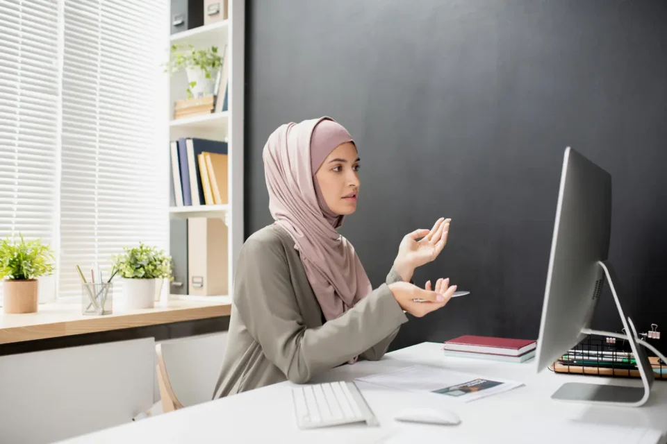 Young muslim female interpreting and explaining something through an online call