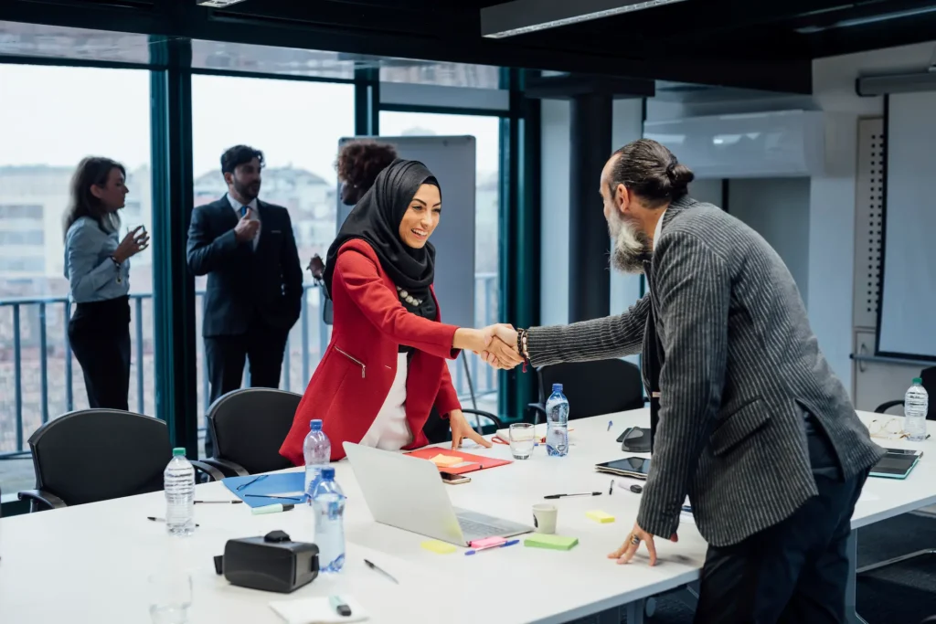 Two Urdu speaking business people shaking hands